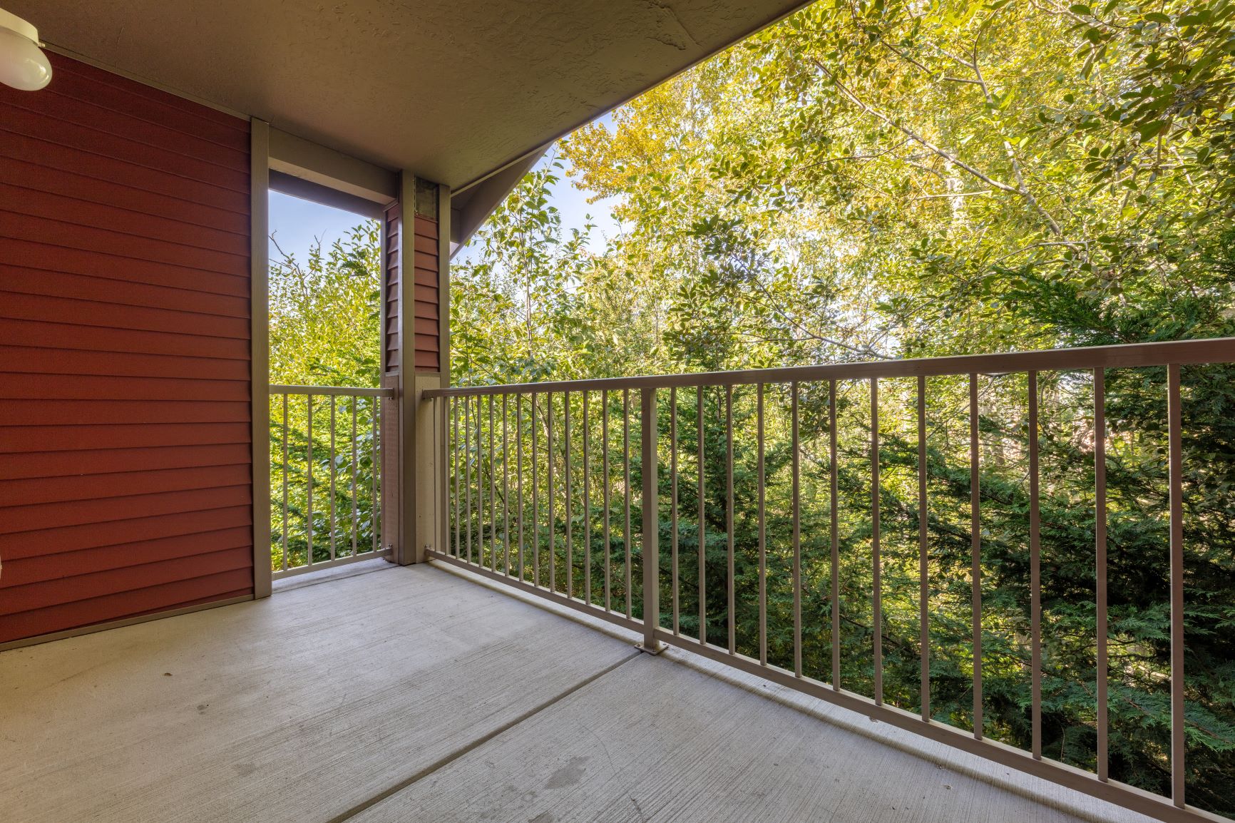 a balcony with a view of trees and a wooded area