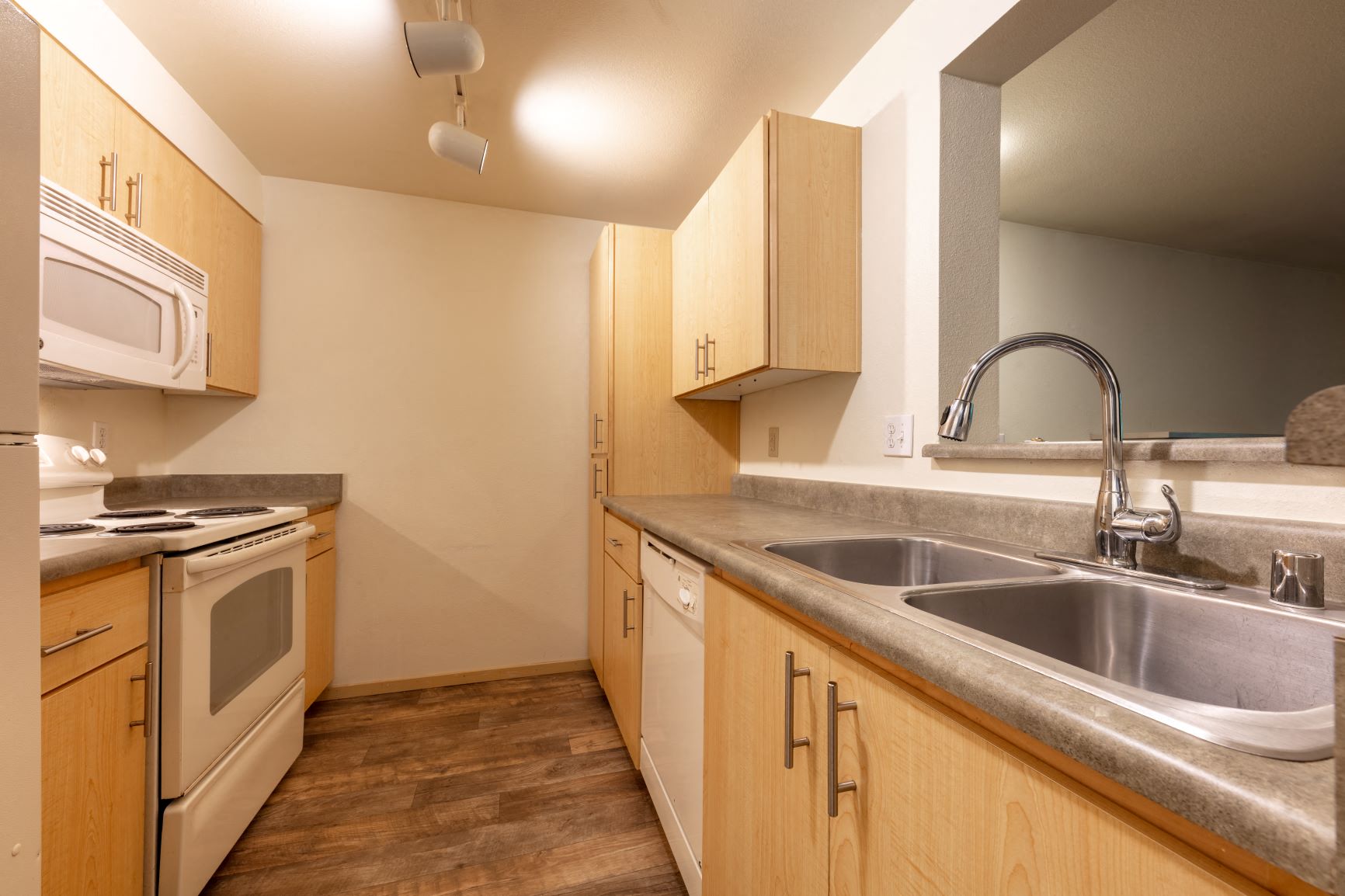 a kitchen with a sink and a stove and a microwave