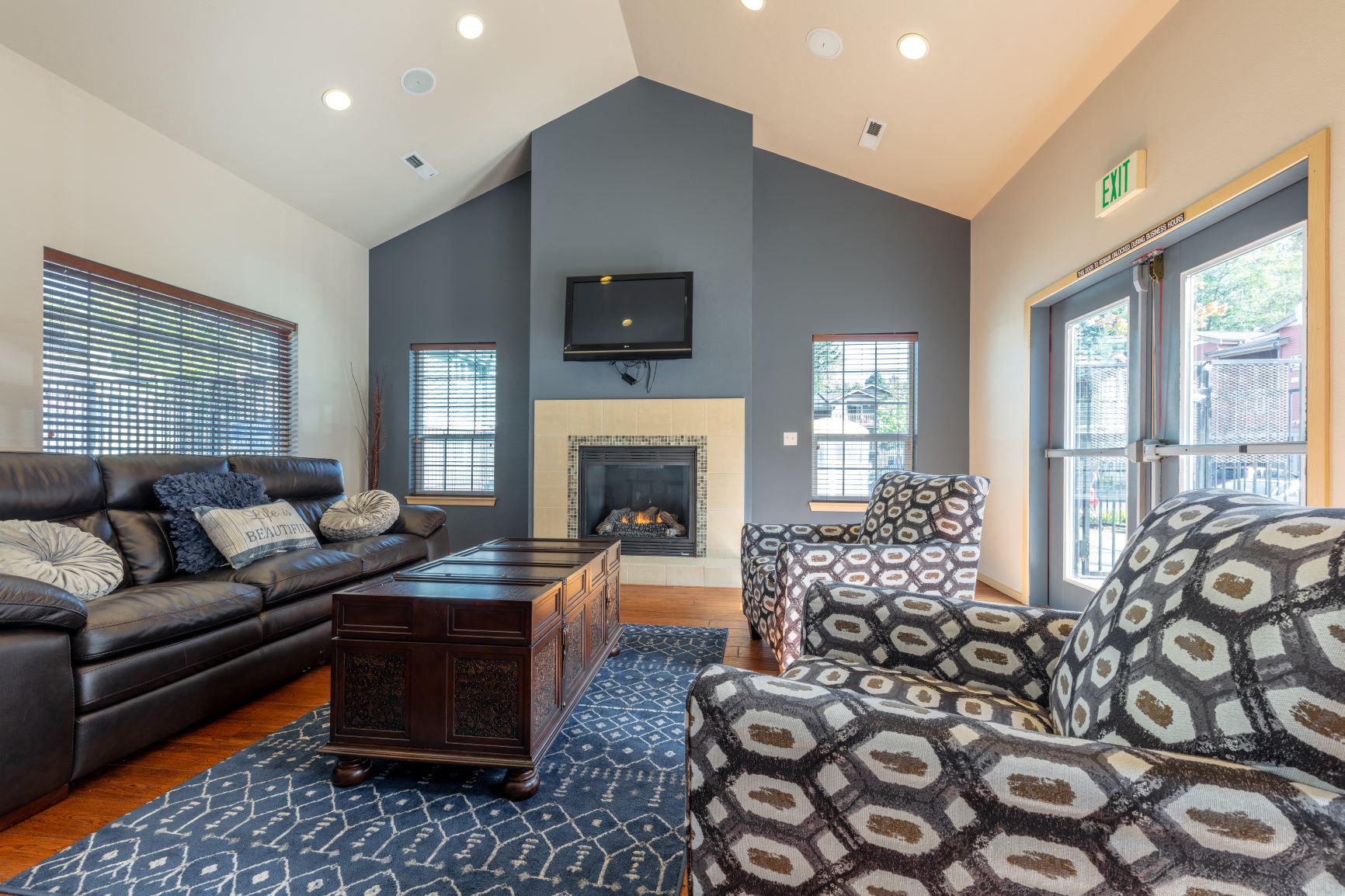 a living room with couches and chairs and a fireplace