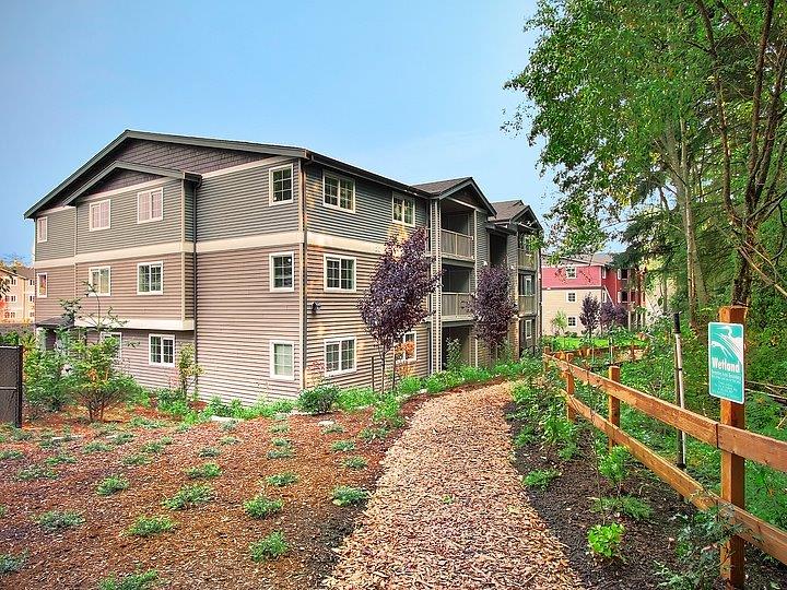 a path in front of a apartment building