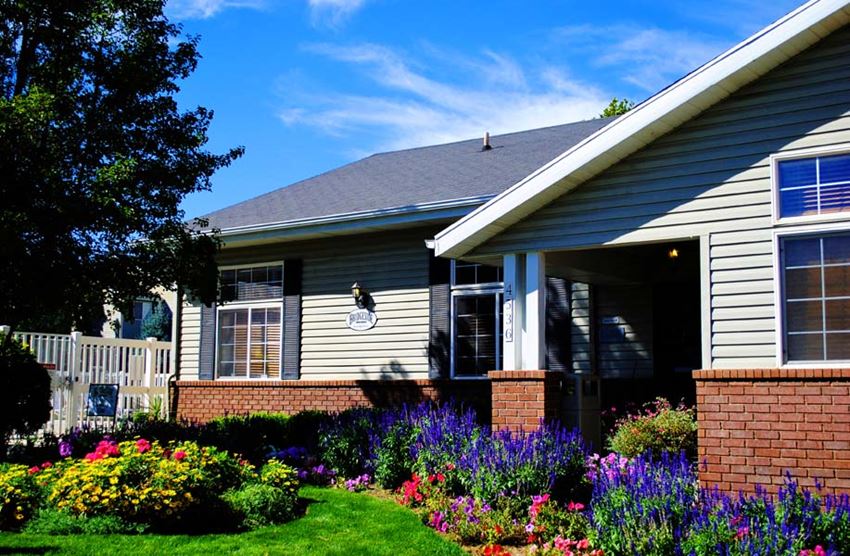 a house with a flower garden in front of it