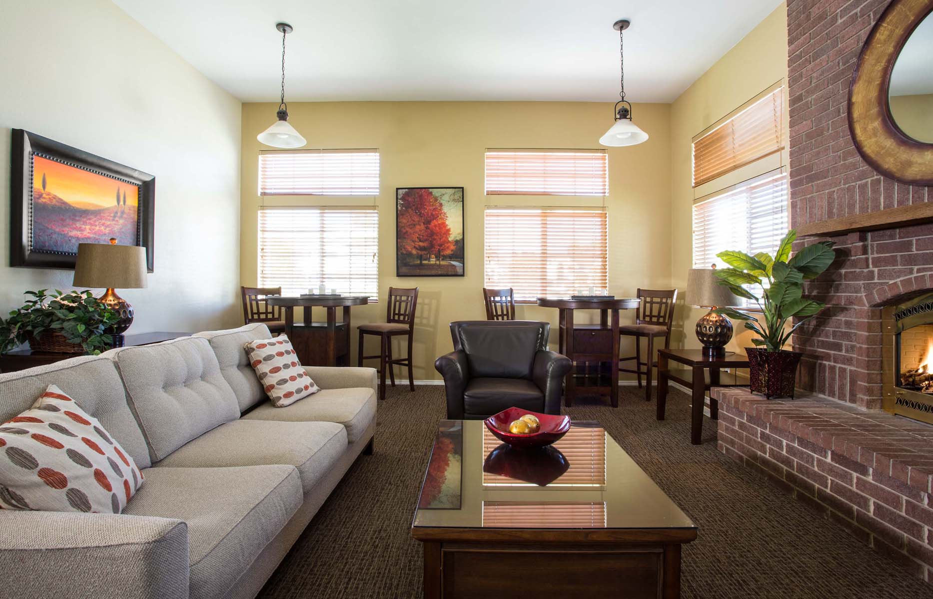 a living room with a couch and a table and a fireplace