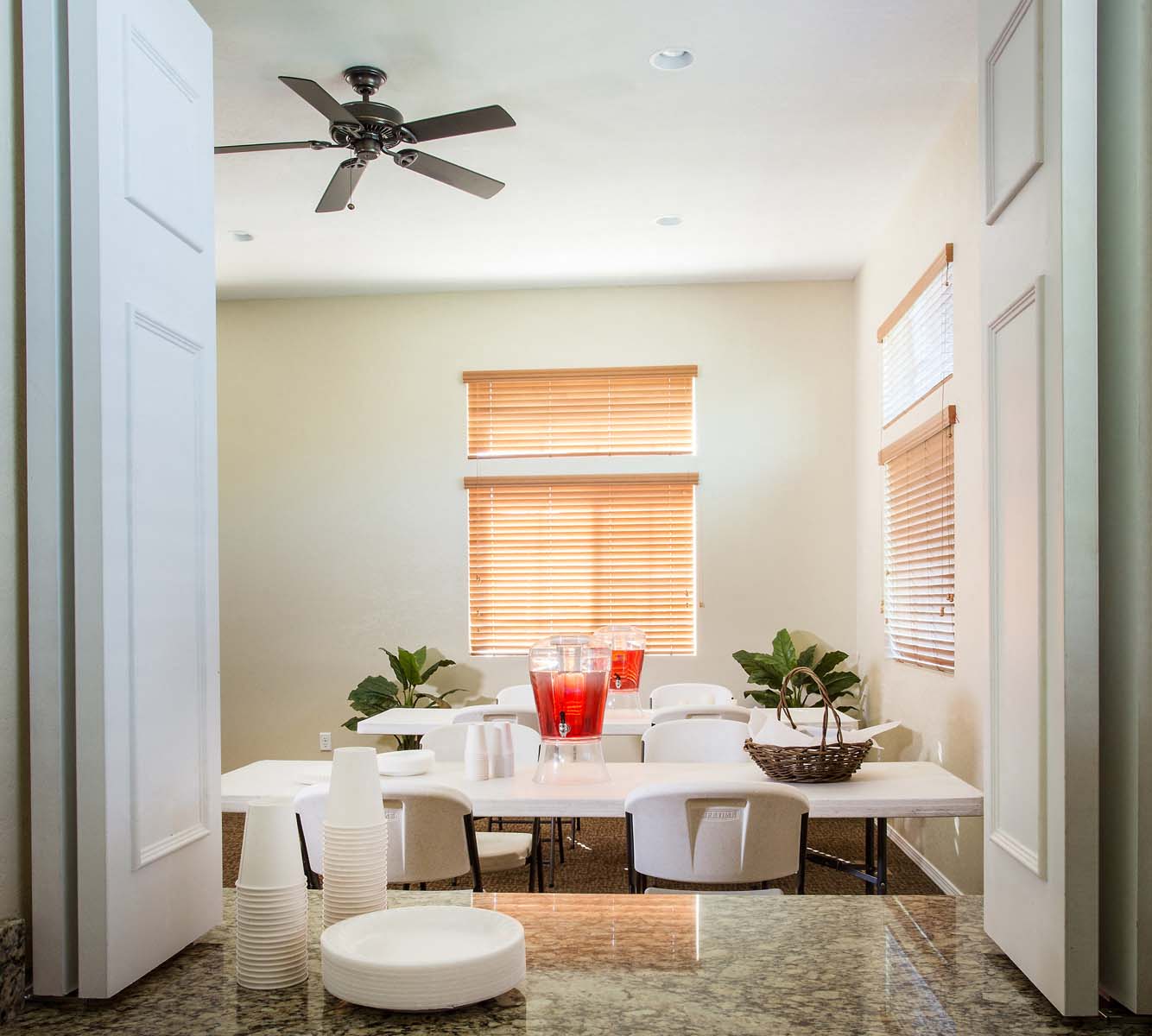 a dining room with a table and chairs and a ceiling fan