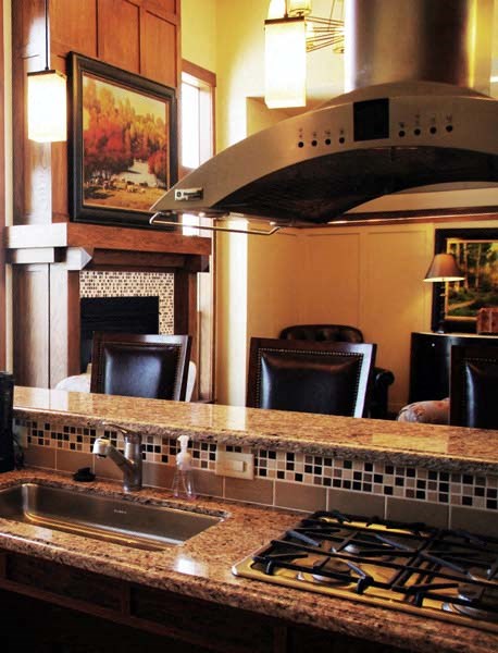 a kitchen with a stove and a counter with chairs