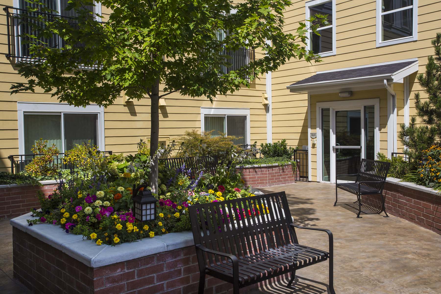 a bench in front of a building with flowers