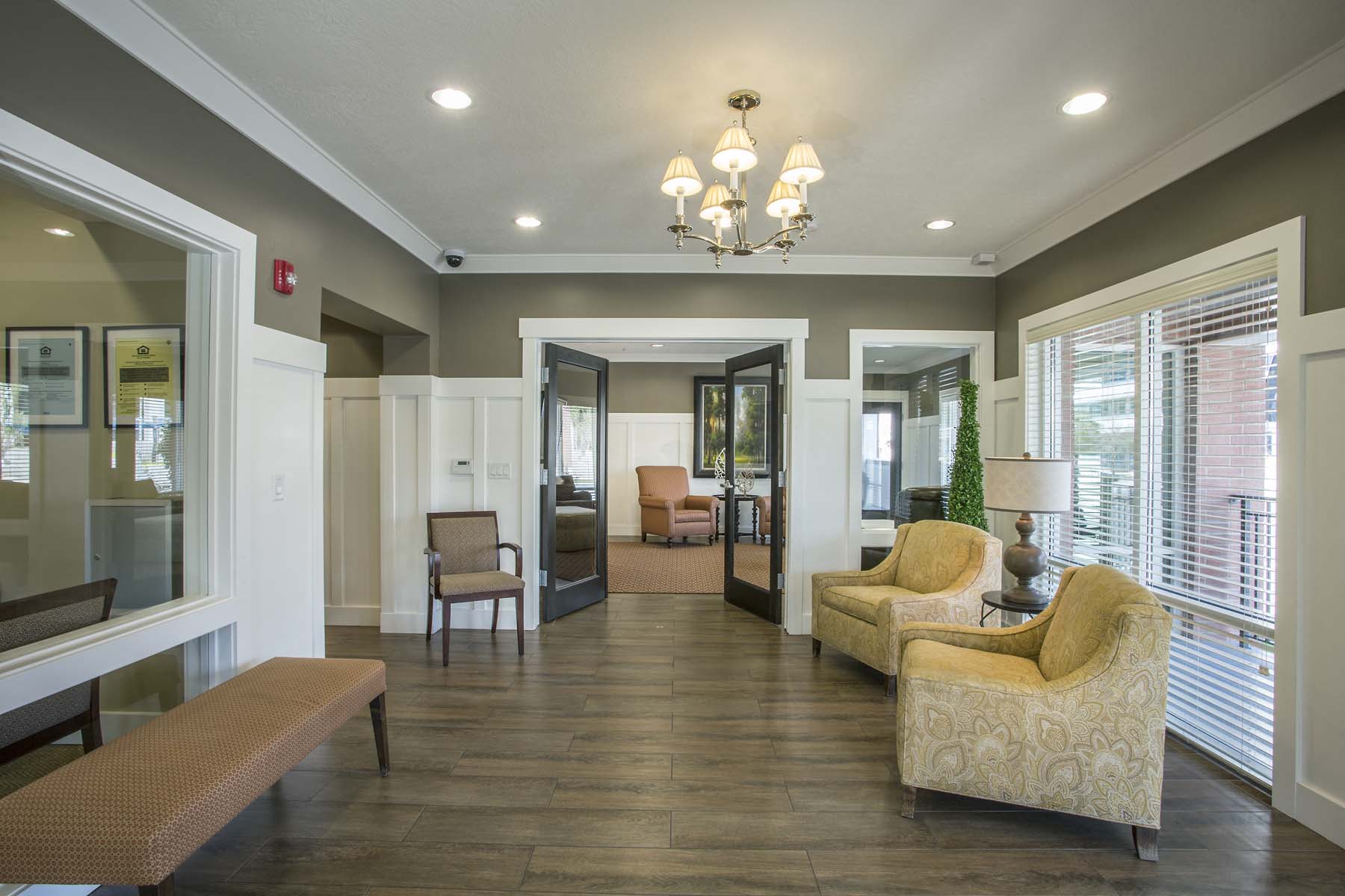 a lobby with couches and chairs and a chandelier