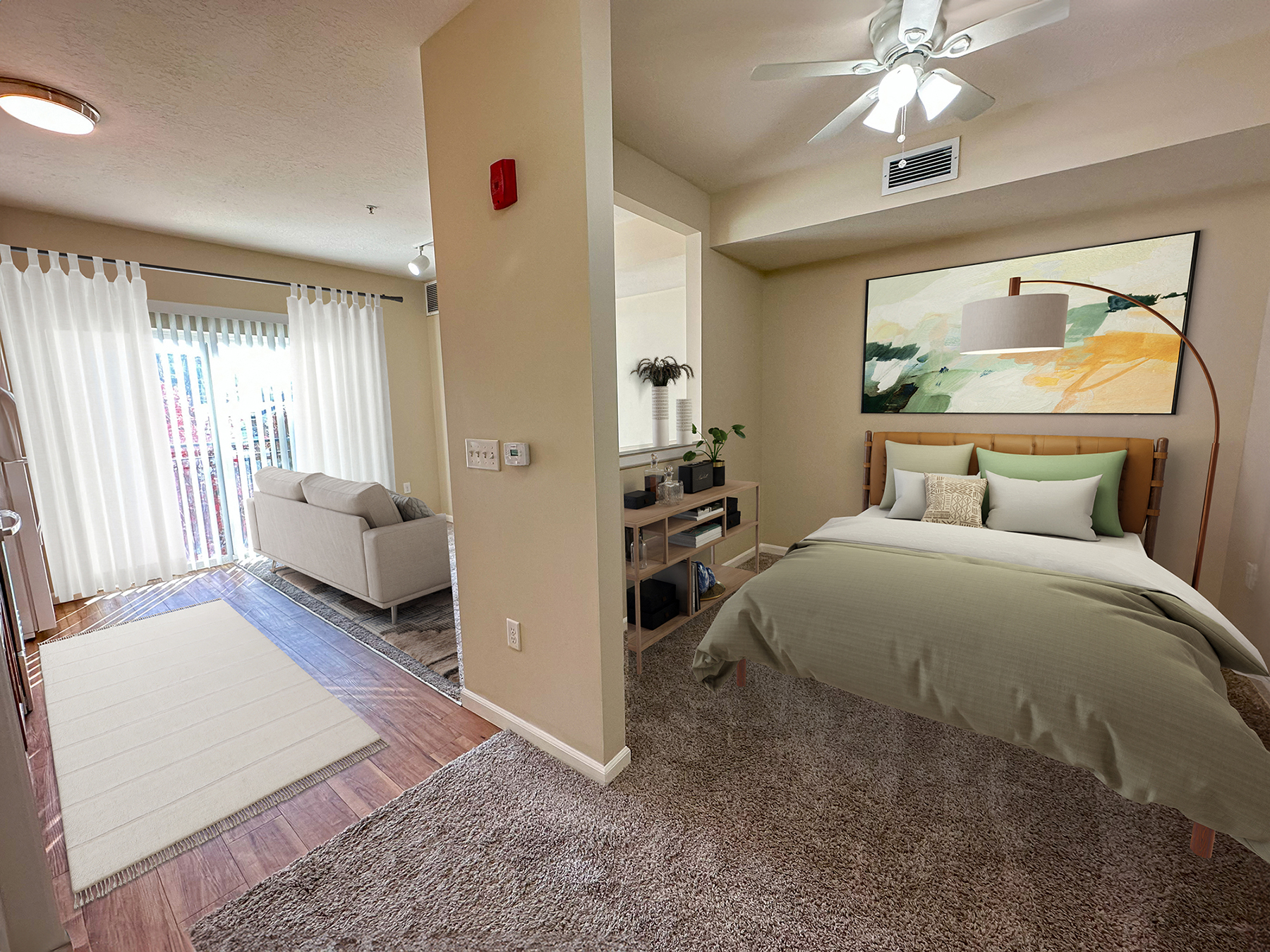 Liberty Citywalk Apartments, Salt Lake City, Utah, studio apartment with half wall, showing a full-size bed looking into the kitchen and living room.