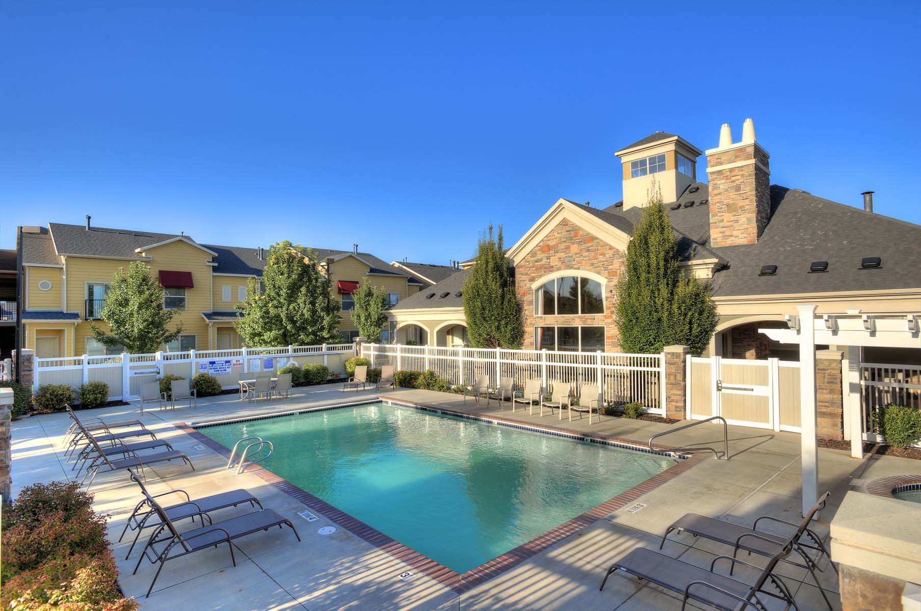 a swimming pool with a house in the background