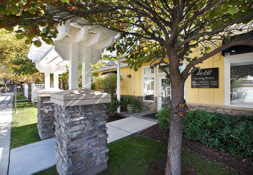Liberty Hill Apartments, Draper, Utah, entrance with white pergola and stone pillars.
