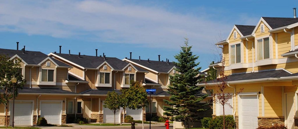 Liberty Hill Apartments, Draper, Utah, a row of yellow townhomes with white garage doors and black roofs.