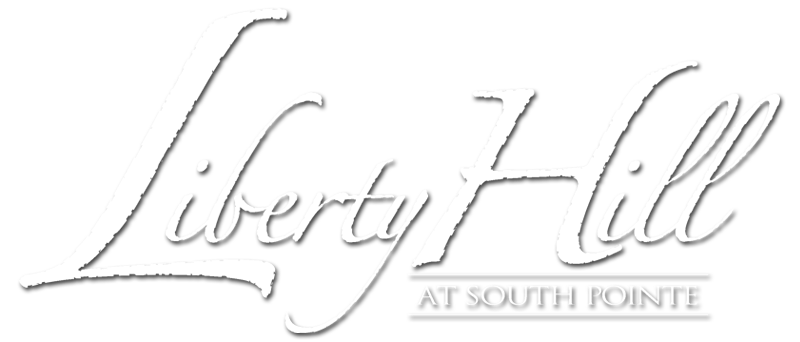 Property entrance sign with elegant script lettering at Liberty Hill Apartments, Draper, Utah