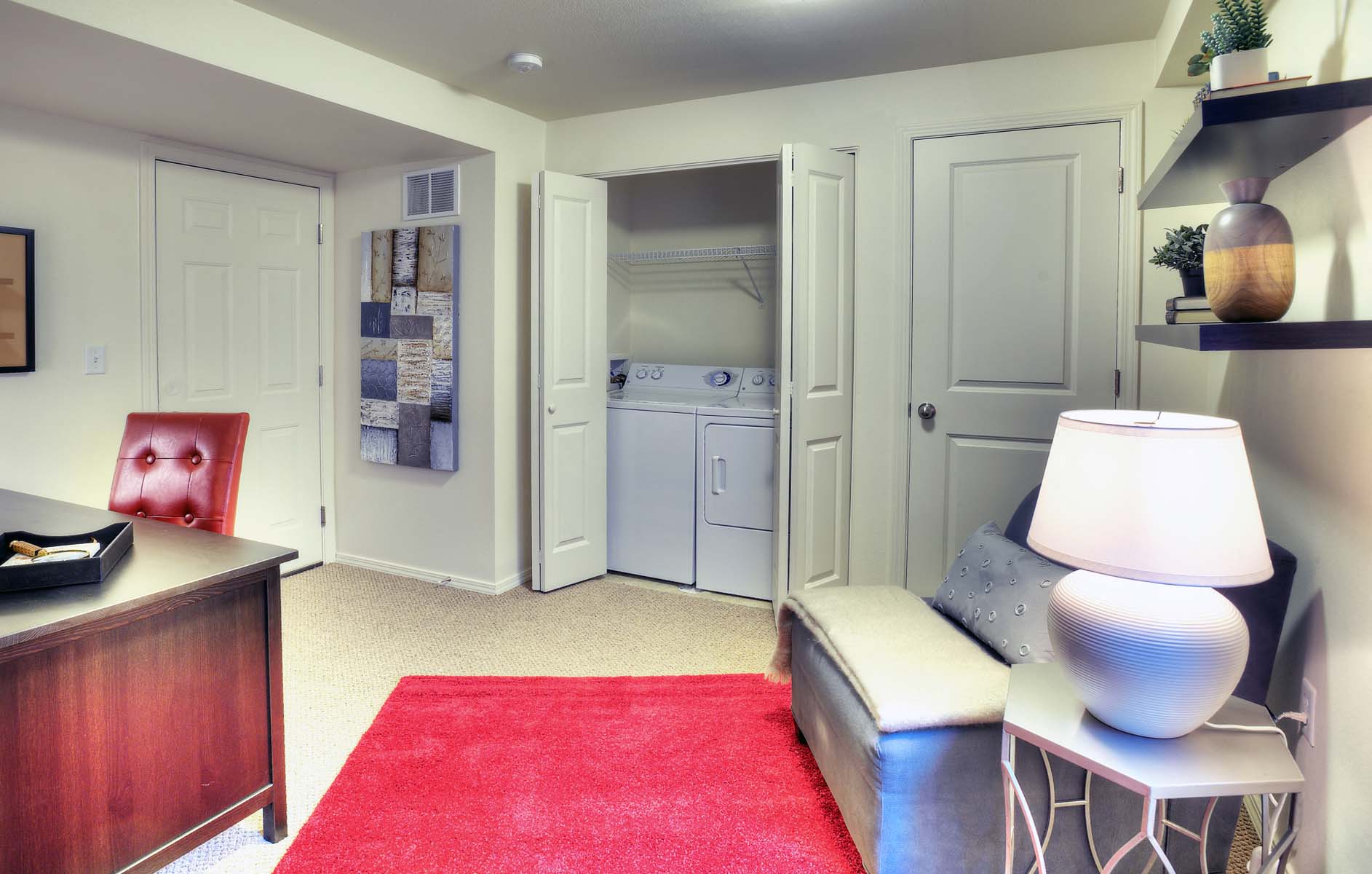 a living room with a couch and a laundry room