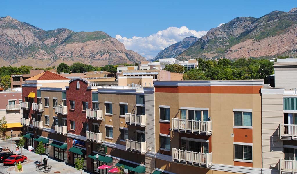 an aerial view of a city with mountains in the background