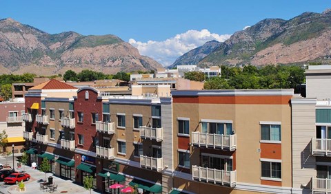 an aerial view of a city with mountains in the background