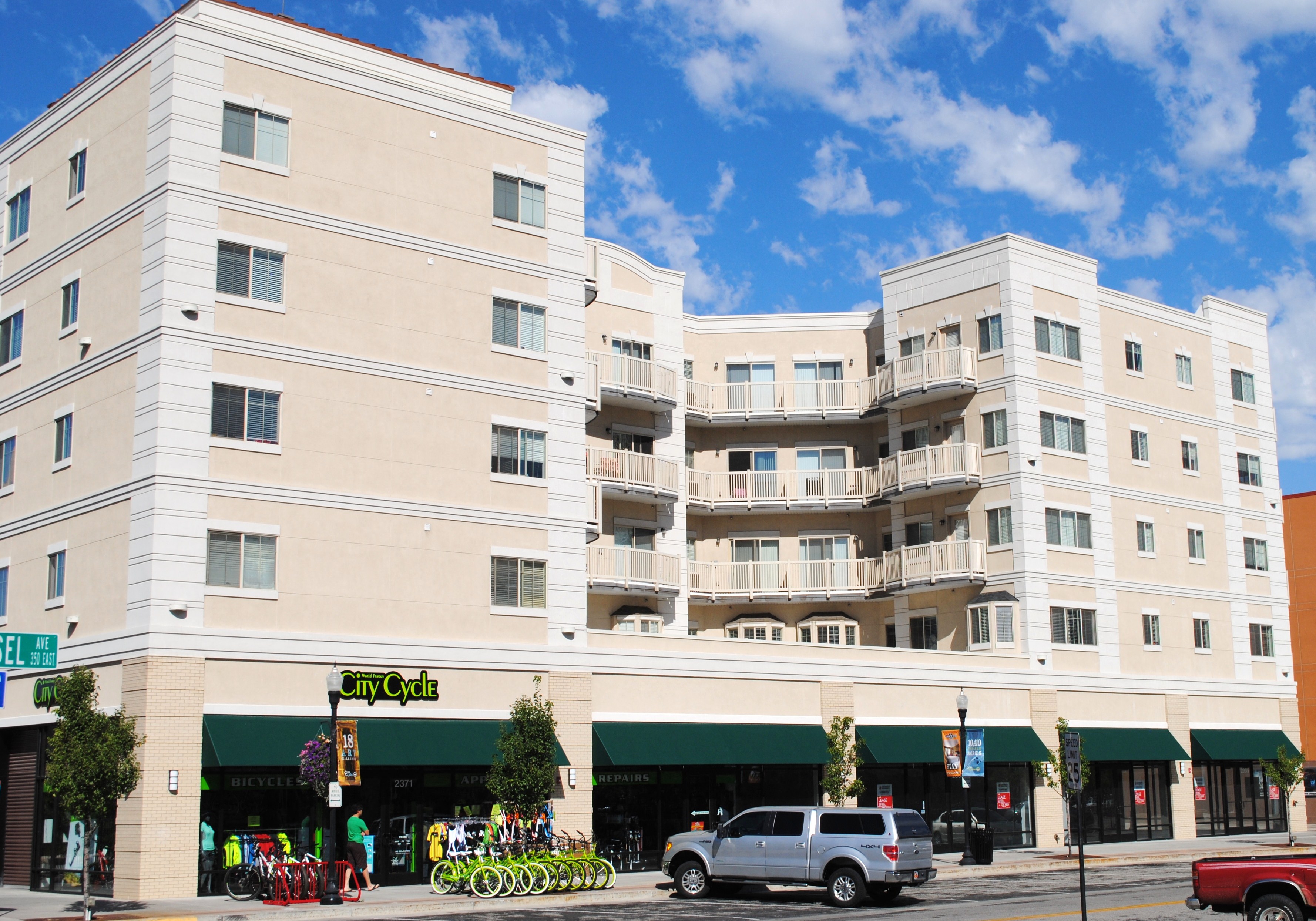 a large white apartment building on a city street