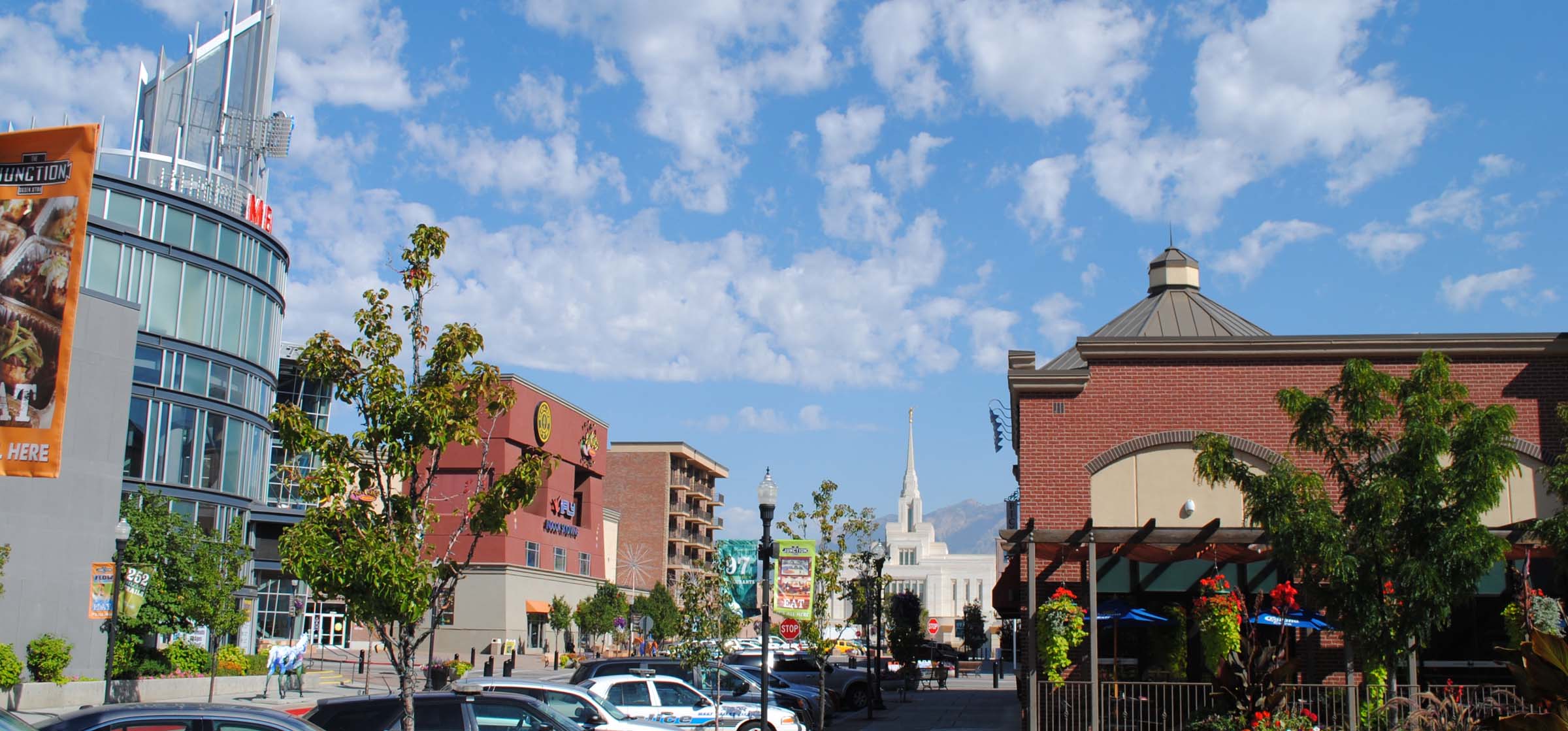 a view of a city street with cars and buildings