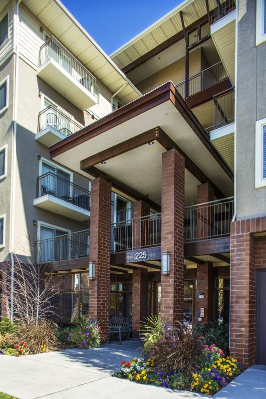 an apartment building with balconies and a sidewalk