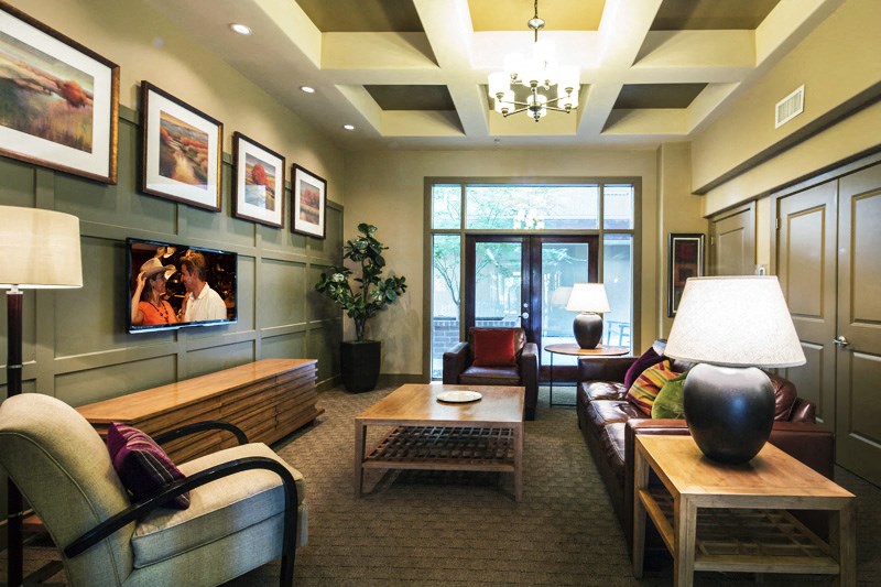 a living room filled with furniture and a large window
