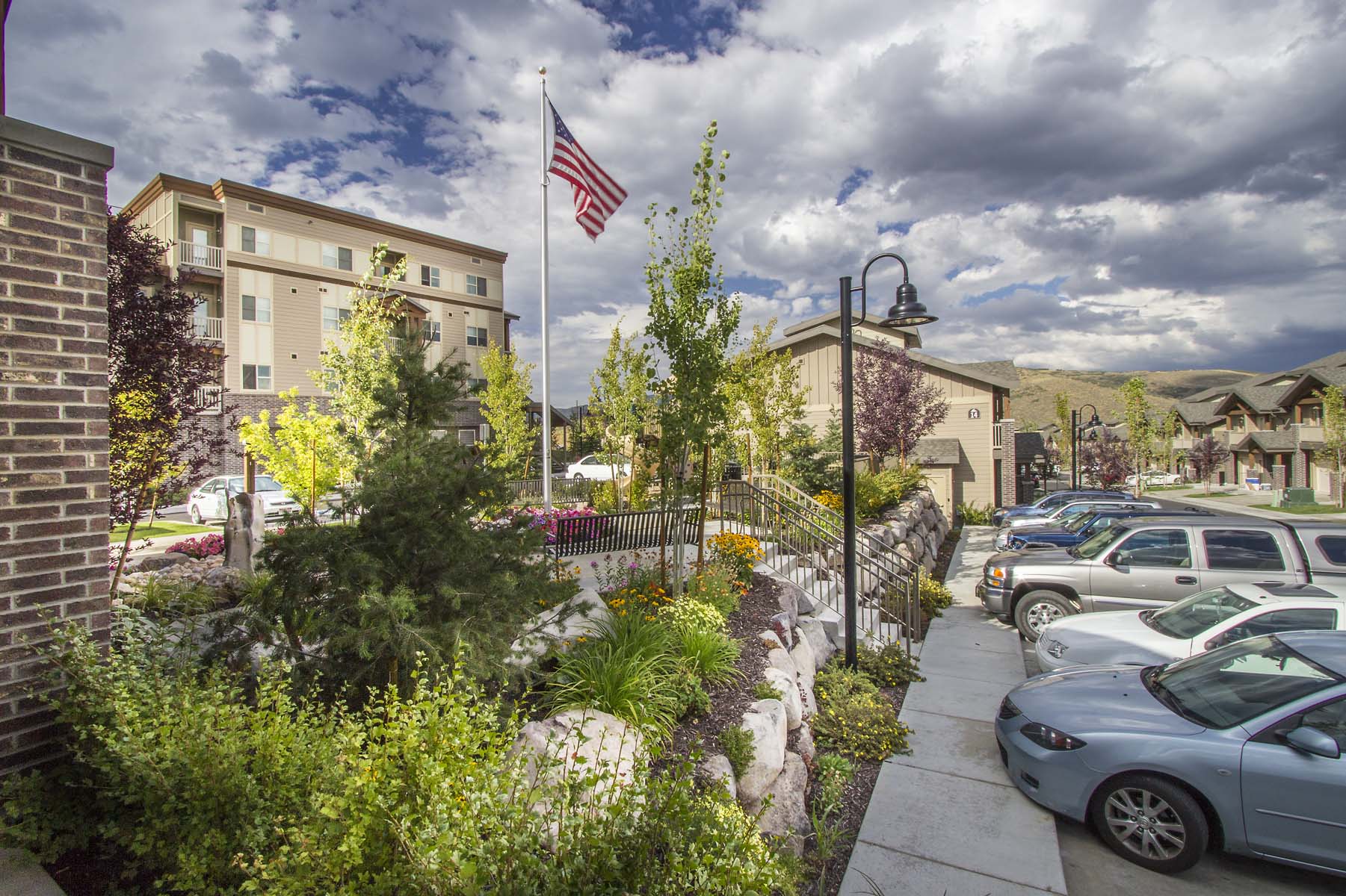 a city street with cars parked in front of a flag