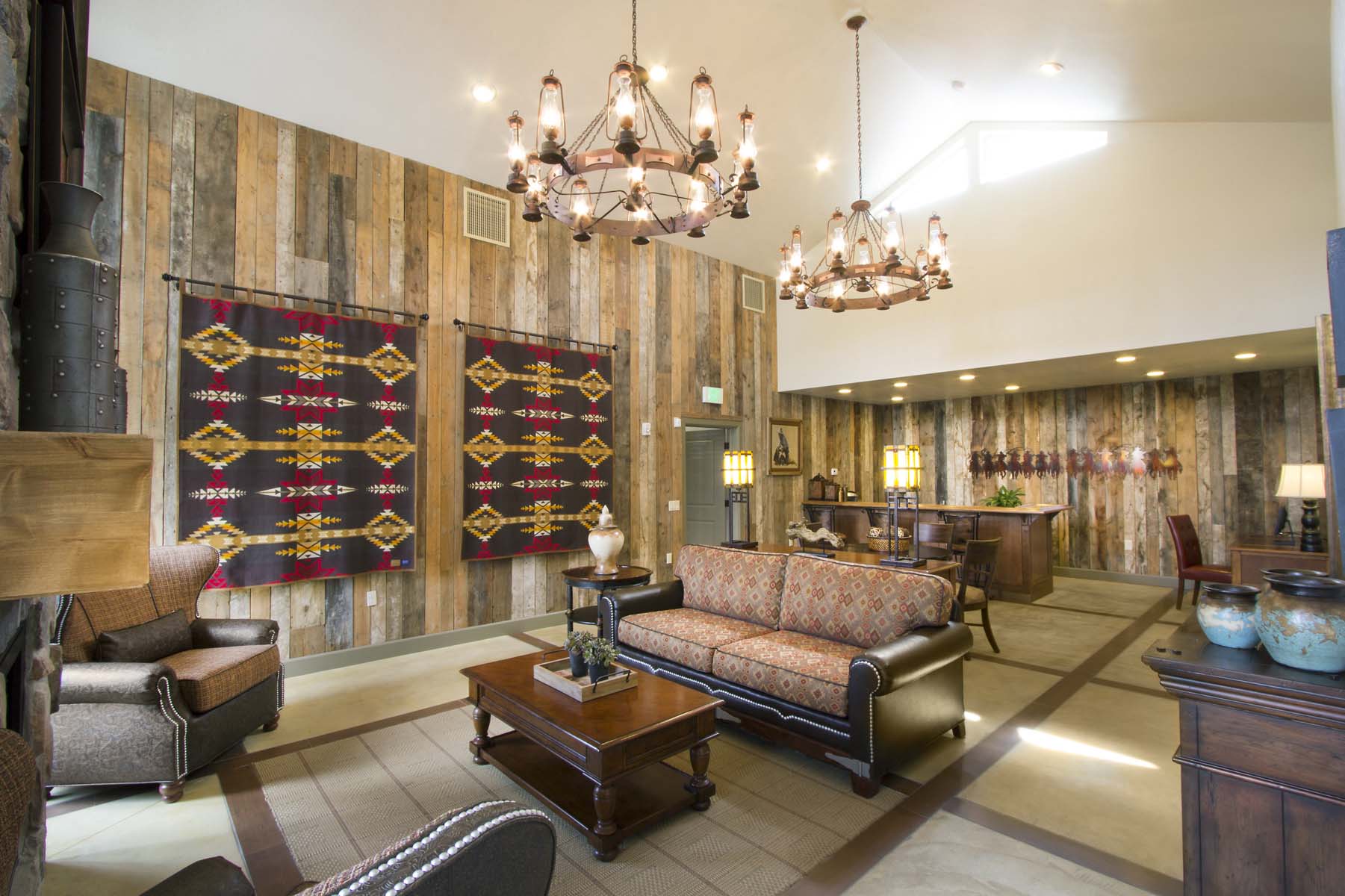 a lobby with couches and chairs and a chandelier