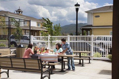 a family sitting around a picnic table