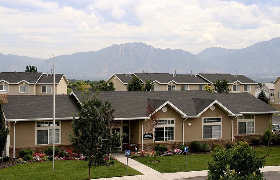 a row of houses with mountains in the background
