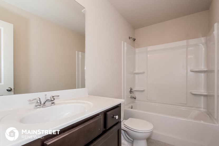 a bathroom with a sink and a toilet and a shower