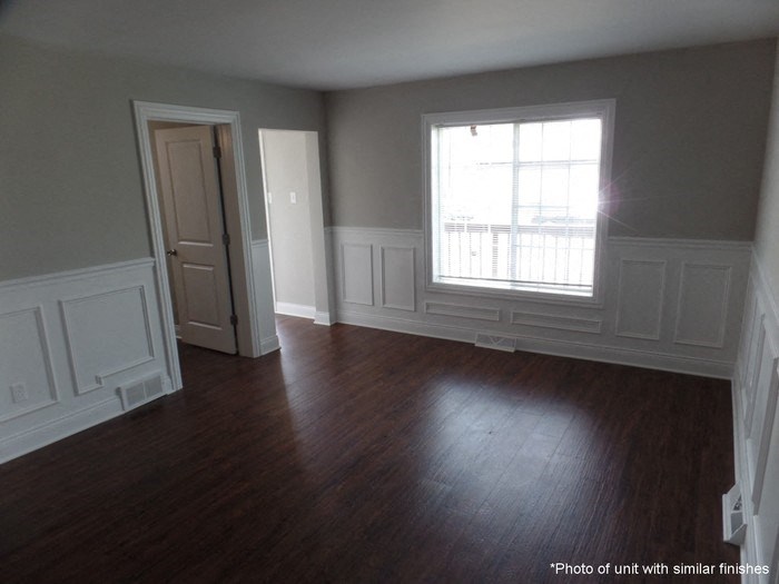 A room with wood floors and white trim.