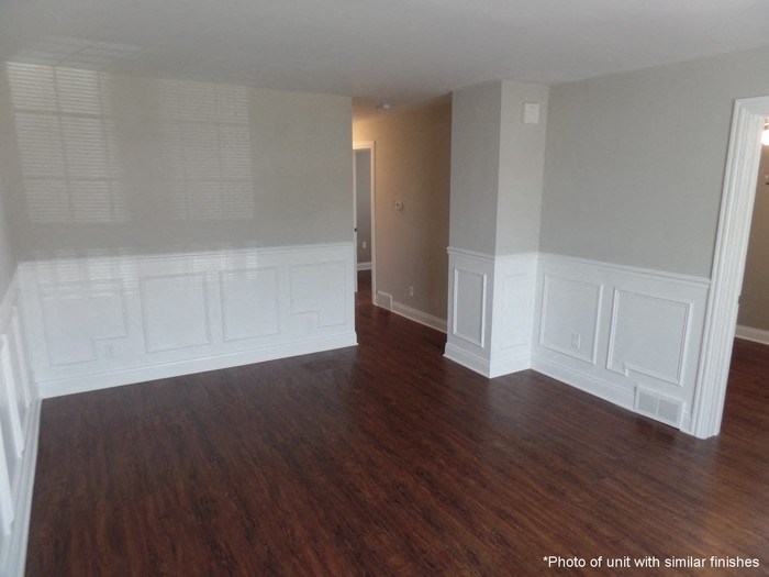 A room with wood floors and white trim.