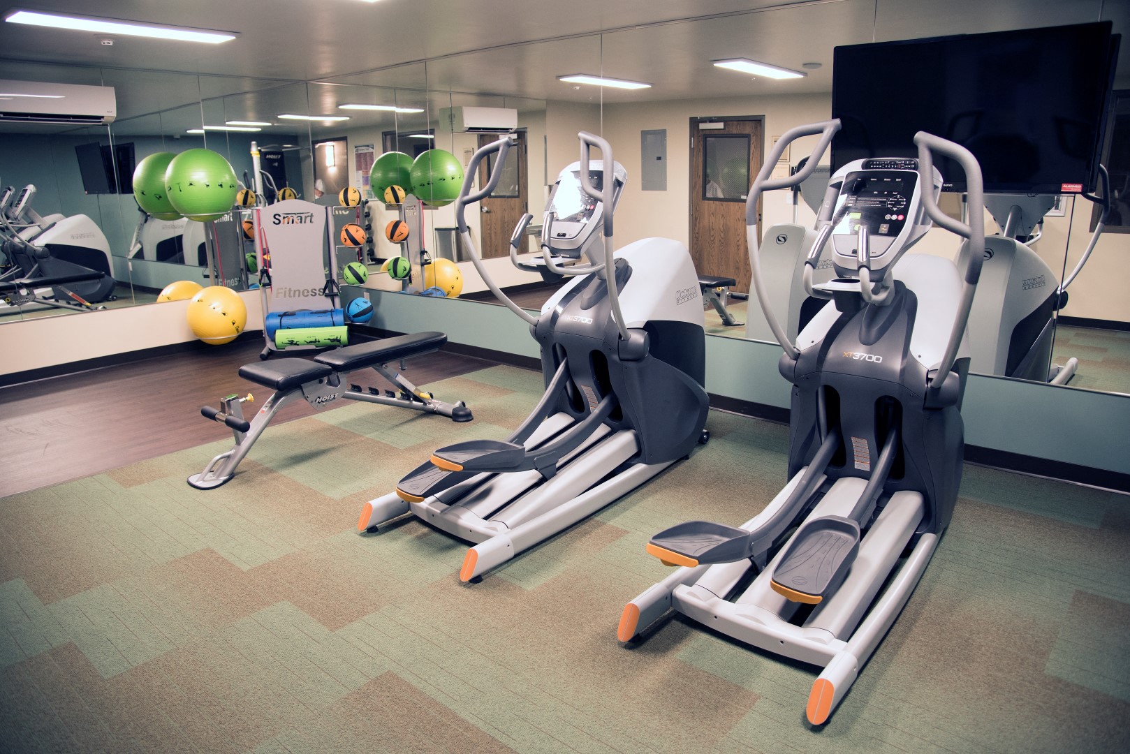 a group of exercise machines in a gym