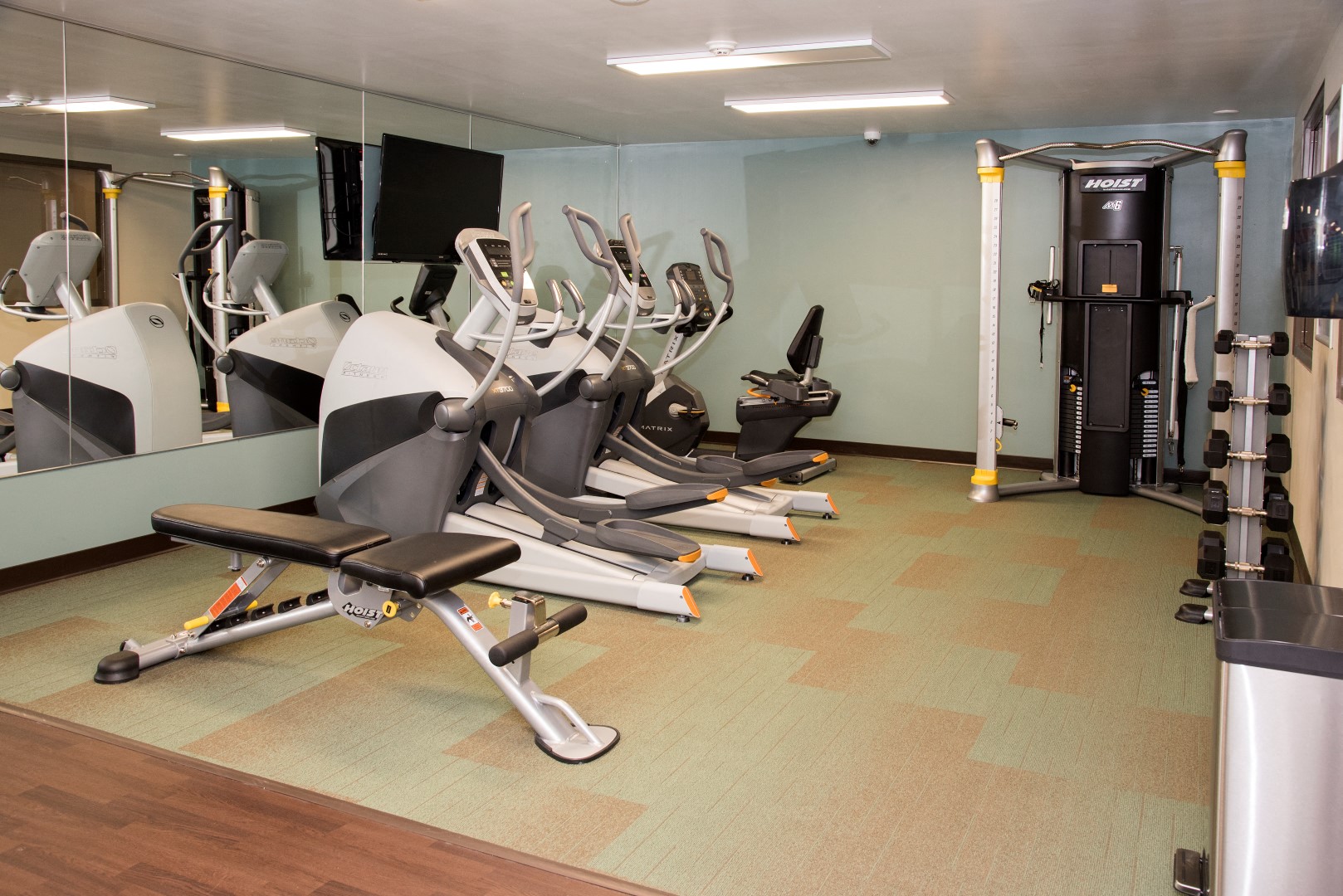 a row of exercise machines in a gym