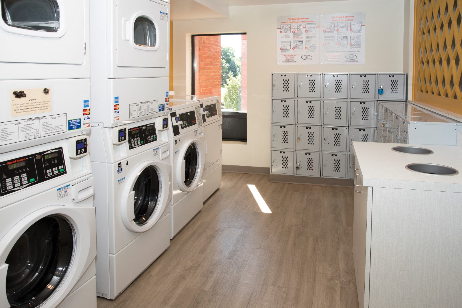 a washer and dryer laundry room with a row of washing machines