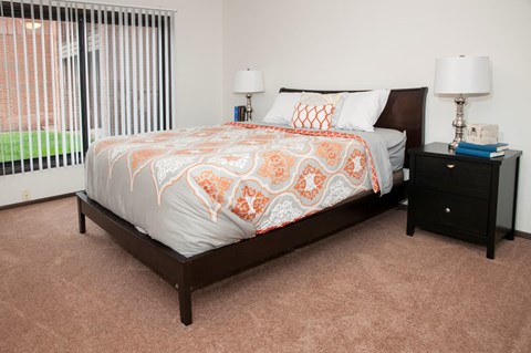 a bedroom with a large bed and a window