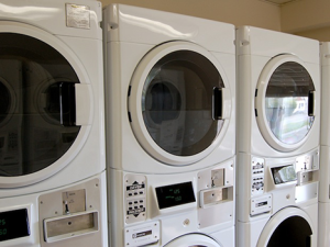 a row of washing machines in a laundry room
