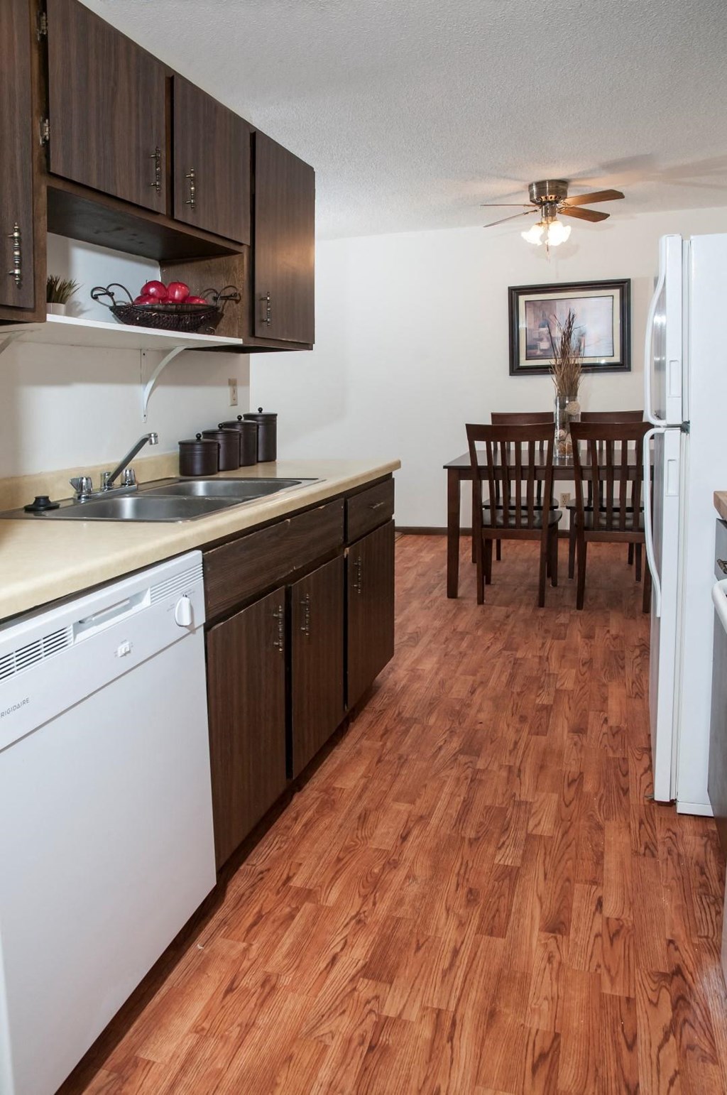 a kitchen and dining room with a wooden floor
