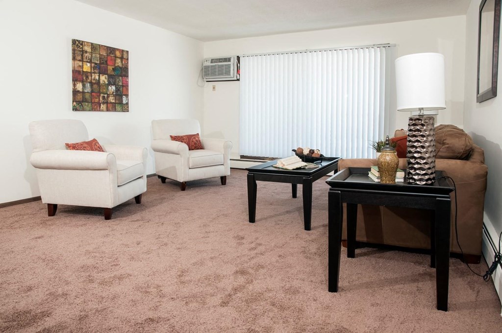 a living room with a couch and chairs and a table
