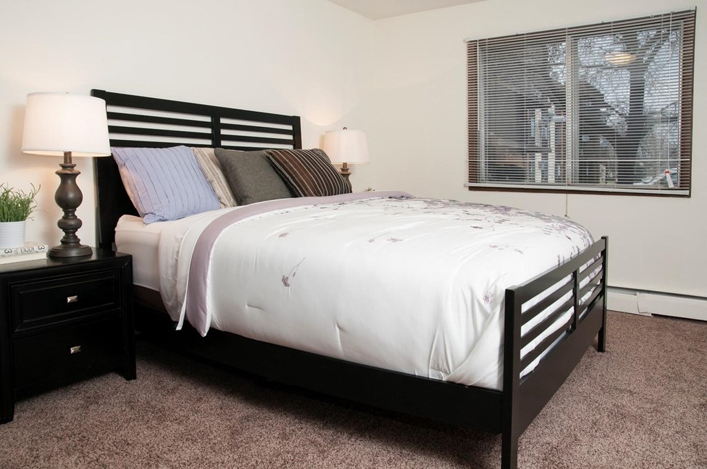 a bedroom with a bed and a window