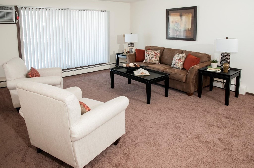 a living room with a couch and chairs