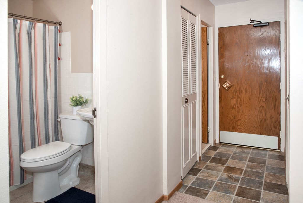 a bathroom with a toilet and a shower