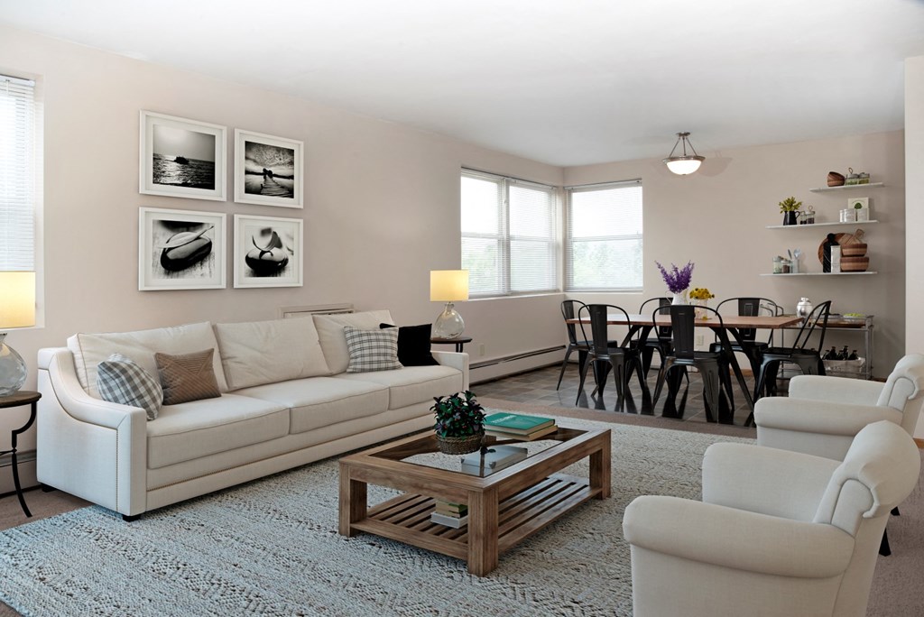 a living room with a couch and chairs and a table