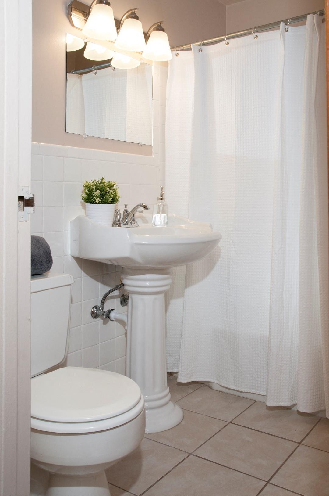 St. Louis Park Apartment Bathroom with Tile Floors and Shower with Bathtub