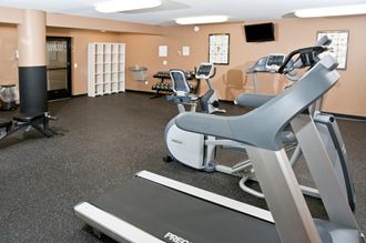 Fitness Room of St. Louis Park Apartment With Cardio Equipment and Free Weights