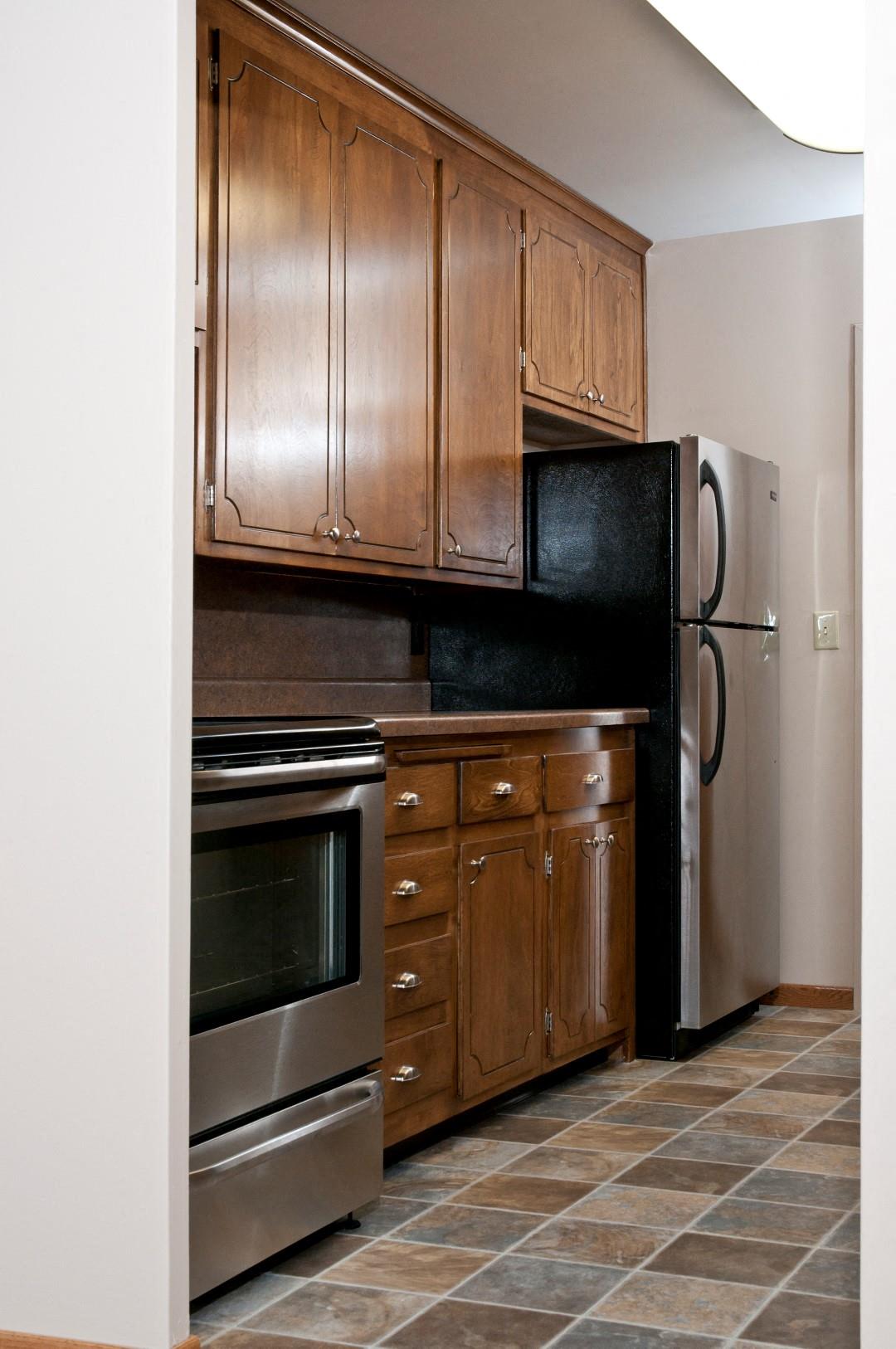 Tile Flooring, Wood Cabinetry at Boulevard 100 Apartments in St. Louis Park, MN
