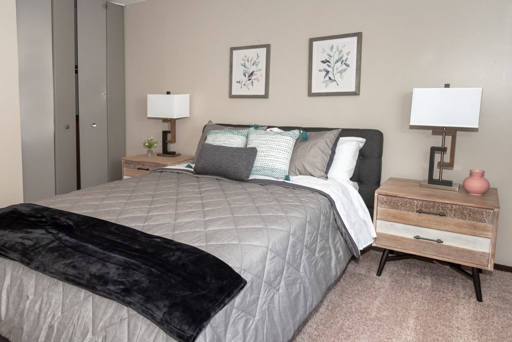 a bedroom with a bed and two lamps