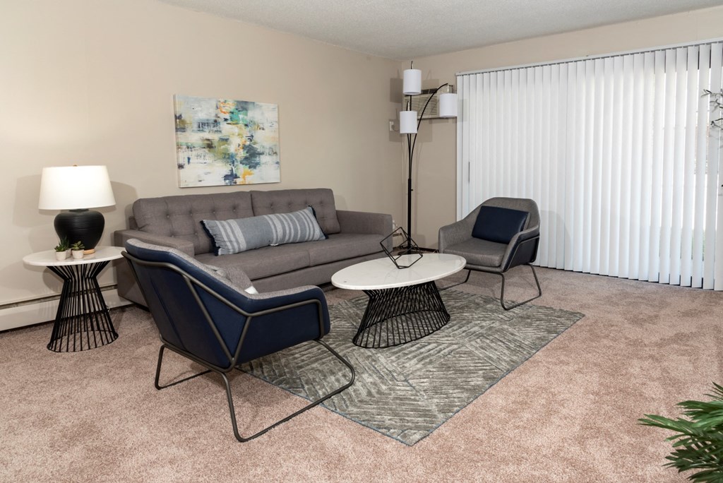 a living room with a couch and two chairs