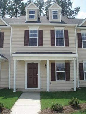a house with a sidewalk in front of it