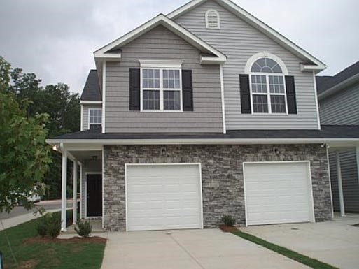 a house with two garage doors and a driveway