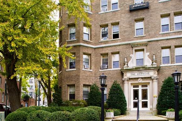 a large brick building with a tree in front of it