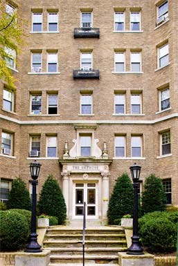 a large brick building with stairs and a front door