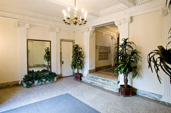 a large room with potted plants and a chandelier